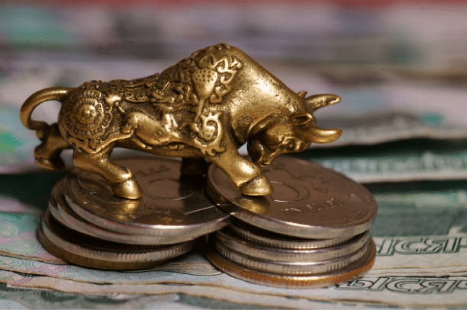 A metal bull with coins and money
